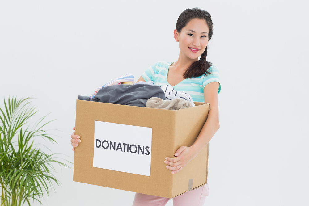 Volunteer holding a box of donations as a result of nonprofit improved donor relationship.